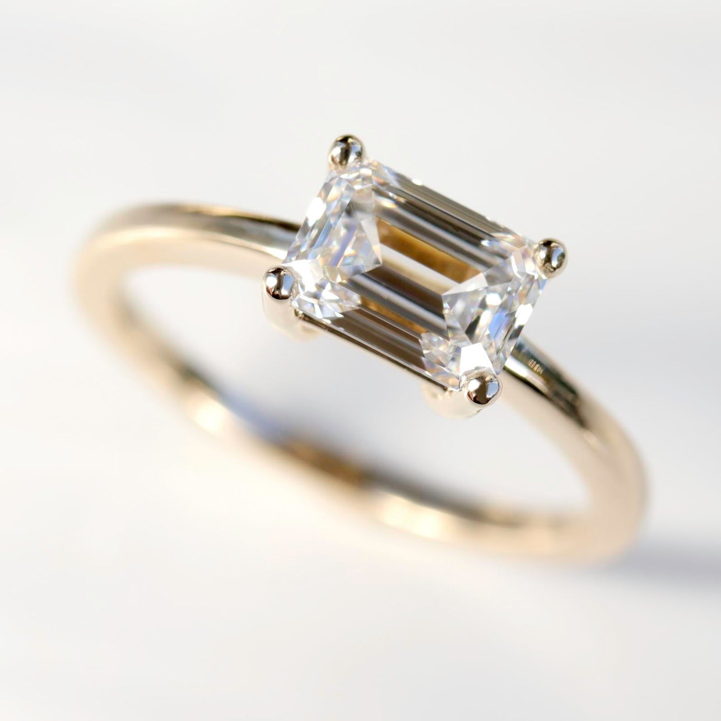 Emerald-cut East-West Basket Solitaire Engagement Ring